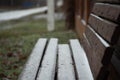 Bench in the village after the first snow, the end of autumn and the beginning of winter Royalty Free Stock Photo