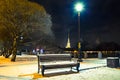 Bench, walkway covered snow and street light at night. Winter cityscape in Saint Petersburg, Russia. Royalty Free Stock Photo