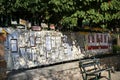 Bench by the wall with full of of posters in Chios Island, in Greece