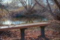 Bench by the water in the winter time Royalty Free Stock Photo