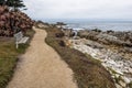 Bench, Waves crushing on a rocky beach making sea foam on Moonstone Beach Royalty Free Stock Photo