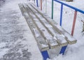 Bench in the winter city Park, covered with snow on a frosty winter day Royalty Free Stock Photo