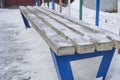 Bench in the winter city Park, covered with snow on a frosty winter day Royalty Free Stock Photo