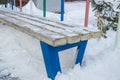 Bench in the winter city Park, covered with snow on a frosty winter day Royalty Free Stock Photo