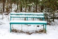 Bench in the winter forest Royalty Free Stock Photo