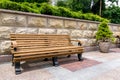 A bench of wooden boards and iron legs in the backyard.