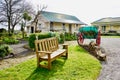 Bench and Wooden trailer in front of the house. Royalty Free Stock Photo