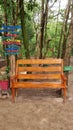 Bench in the woods, next to signs with positive sayings