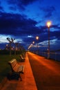 Benches and lampposts in a park at night