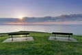 Benches near sea at sunset