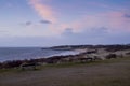 Benches overlooking a beach at sunset