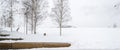 Benches in Park Covered in Snow near Trees in Winter Royalty Free Stock Photo