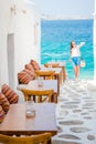 Outdoor cafe in a typical greek outdoor cafe in Mykonos with amazing sea view on Cyclades islands Royalty Free Stock Photo