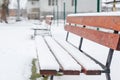Benches for rest are covered with snow in the park in winter Royalty Free Stock Photo