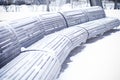 Benches standing in park and covered with snow