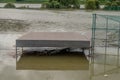 Benches submerged by flood water at baseball diamond