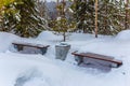 Benches and urn covered with snow on a path