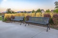 Benches and water fountain against homes and sky Royalty Free Stock Photo