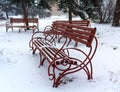 Benches during winter in park covered Royalty Free Stock Photo