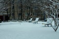 Benches in the yard covered with snow