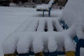 Benches in the yard covered with snow