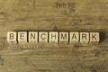 Benchmark word on a wooden cubes on a wooden background