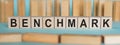 BENCHMARK word written on wooden blocks on light blue background