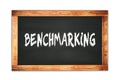 BENCHMARKING text written on wooden frame school blackboard Royalty Free Stock Photo