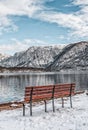 Benchs by lake with view of snow mountain during winter in Hallstatter, Austria