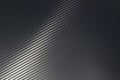 Bended surface of grey woven carbon fibre composite sheet. Royalty Free Stock Photo