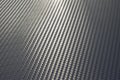 Bended surface of grey woven carbon fibre composite sheet. Royalty Free Stock Photo