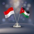 Indonesia VS Jordan flag Relation in a stand on table Royalty Free Stock Photo