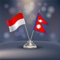 Indonesia VS Nepal flag Relation in a stand on table Royalty Free Stock Photo