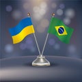 Ukraine VS Brazil flag Relation in a stand on table Royalty Free Stock Photo