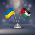 Ukraine VS Jordan flag Relation in a stand on table Royalty Free Stock Photo