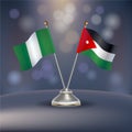 Nigeria VS Jordan flag Relation in a stand on table Royalty Free Stock Photo