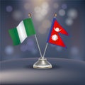 Nigeria VS Nepal flag Relation in a stand on table Royalty Free Stock Photo