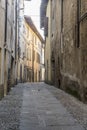 Bending  cobbled narrow lane in historical town, Rovato, Italy Royalty Free Stock Photo