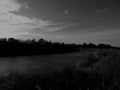 Bending river with banks on a black and white photo