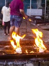 Molten candles igniting on a wax filled tray,at iconic shrine next to the Bell Tower of Dumaguete,Negros Oriental,Philippines
