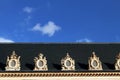 Paris roof with ornamental rounded windows blue sky