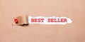 Beneath the torn strip of kraft paper attached with a red button is a white paper labeled BEST SELLER Royalty Free Stock Photo