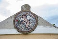 Roof with an antique oval mosaic of a winged cherub bringing a rose. Royalty Free Stock Photo