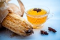 Beneficial detoxifying corn tea in a glass cup isolated on white along with some Star anise spice.Raw corn cob also present