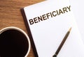 BENEFICIARY - text on notepad on wooden desk Royalty Free Stock Photo