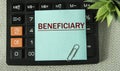 BENEFICIARY - word on the note sheet on the background of the calculator