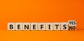 Benefits symbol. Turned a wooden cube and changed words `benefits no` to `benefits yes`. Beautiful orange background. Business