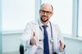 benevolent doctor holding out his hand for a handshake. Royalty Free Stock Photo