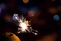 Bengal fire sparkles against the background of city lights, blurred bokeh Royalty Free Stock Photo