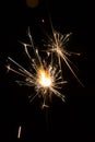 Bengal fire sparkles against the background of city lights, blurred bokeh Royalty Free Stock Photo